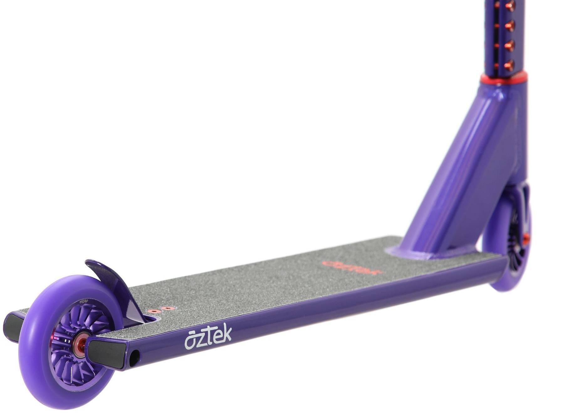 Close-up of the Aztek Architect 2 Complete Stunt Scooter in Viola Purple, featuring the deck with a textured black grip, visible rear wheel, handlebar stem, and the "Aztek" brand name printed on the side of this durable stunt scooter.