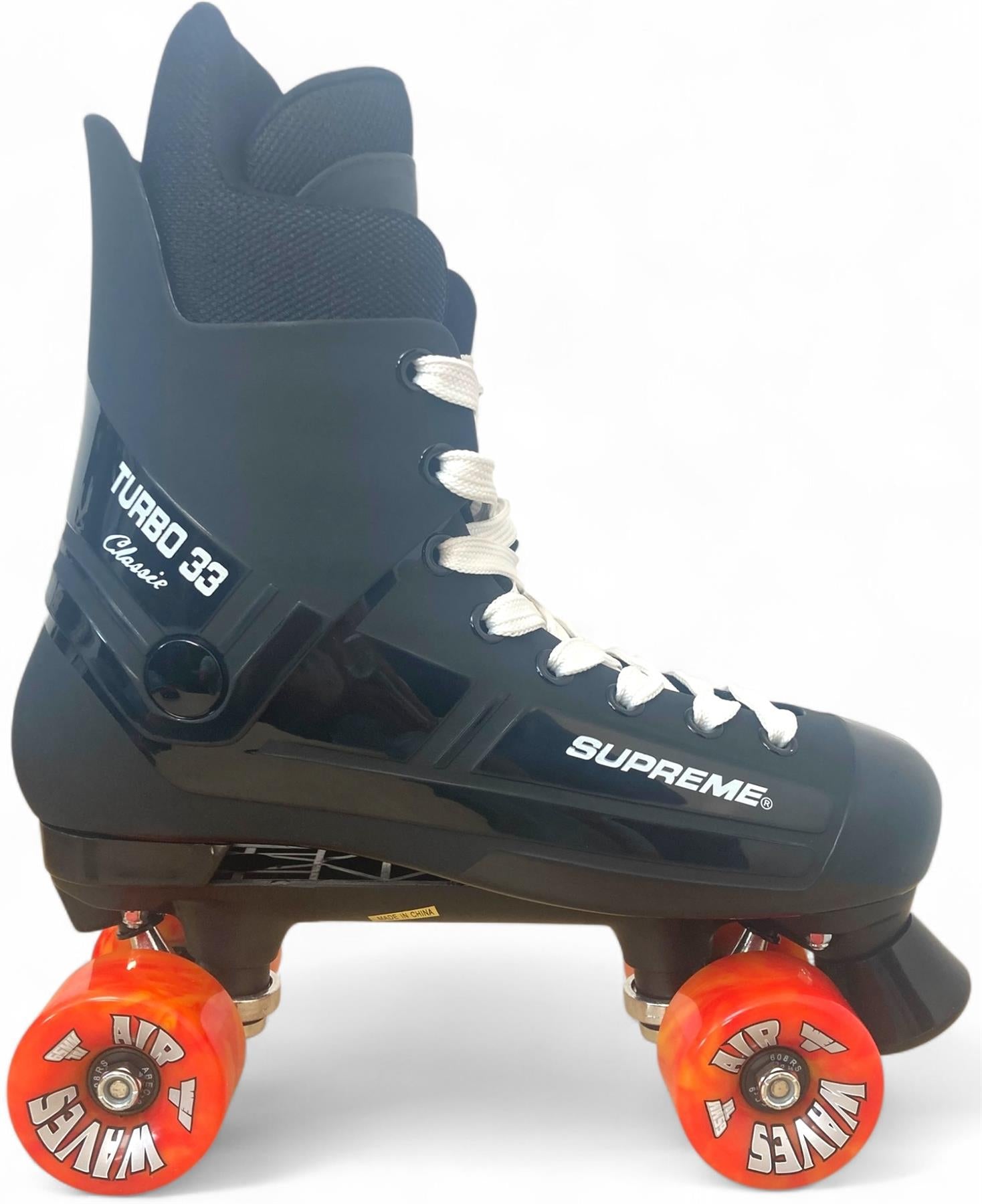 A Supreme Turbo 33 Nylon Quad Roller Skate in black with red swirl wheels and "SUPREME" branding on the boot, shown against a plain white background.