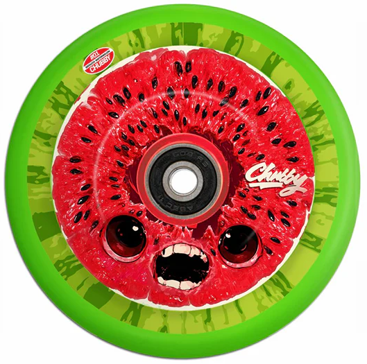 The Chubby Hollowcore 110mm Stunt Scooter Wheel - Watermelon by Chubby features a green wheel with a red watermelon slice center, cartoon eyes, an open mouth, scattered seeds, and "Chubby" on the side—perfect for stunt scooters.