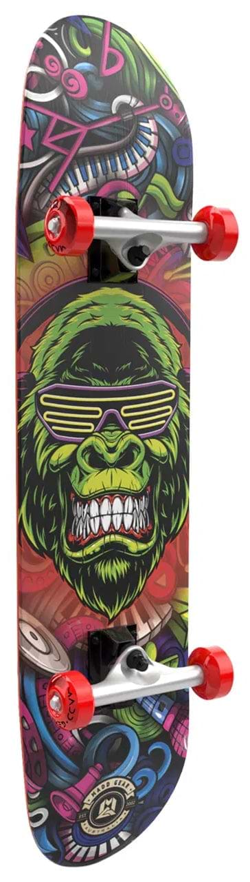 The Madd Gear MGP Pro Series BOOM'N LE Complete Skateboard (8" x 31") features red wheels and graffiti-style art of a green gorilla in striped sunglasses, surrounded by vibrant patterns—ideal for beginner skateboarders.