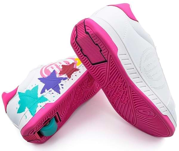 The Breezy Rollers Splash Shoes - White / Pink by Breezy Rollers feature bright pink soles, colorful star designs, and a patented heel wheel system for easy transition between walking and skating.