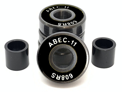 A set of four Logic ABEC 11 Black Scooter Bearings is shown, with one bearing turned to display its label. These high-performance bearings, from the brand Logic, include two cylindrical spacers positioned on each side against a white background, emphasizing their speed capabilities.