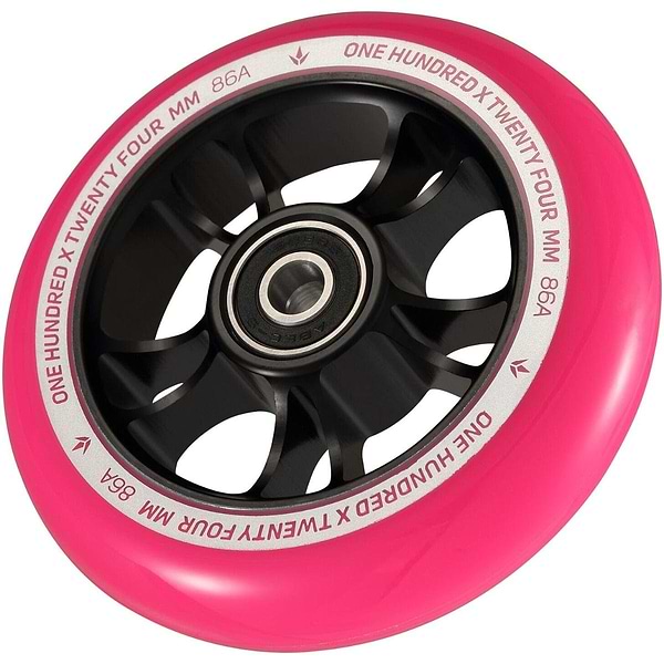 A detailed image showcasing a Blunt Envy 100mm Stunt Scooter Wheel in black and pink. The text "ONE HUNDRED X TWENTY FOUR MM 86A" is prominently displayed along the pink outer edge. This wheel, designed by Blunt Envy, boasts a robust aluminum core and ABEC 9 bearings for optimal performance.