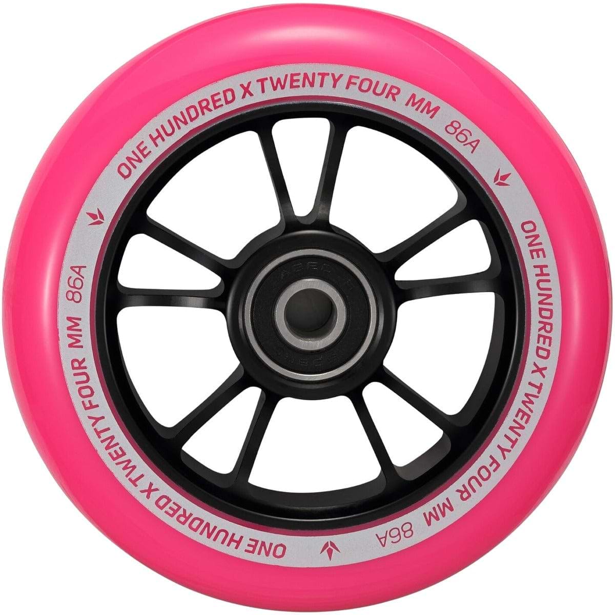 Close-up of the Blunt Envy 100mm Stunt Scooter Wheel in black and pink, featuring an aluminum core with ABEC 9 bearings. White text on the inner rim reads "One Hundred x Twenty Four mm 86A." The wheel showcases a sleek black hub with multiple spokes.