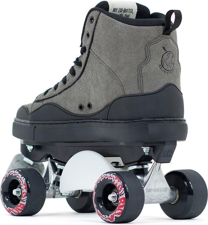 A close-up of the Rio Roller Ramp Quad Roller Skates in grey by Rio Roller, featuring gray suede high-tops, black laces and sole, metal plate, and four wheels with a red and white shark teeth design on the sides.