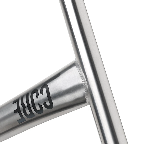 Close-up of a welded joint on a brushed metal frame, with "CORE" printed in black—showcasing the premium craftsmanship of CORE Nova V2 Titanium Oversized HIC Stunt Scooter Bars (Raw, 630mm x 610mm).