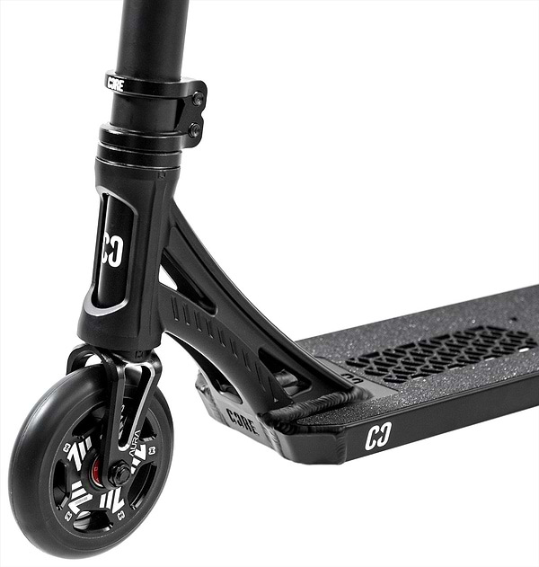 Close-up of the CORE SL3 Complete Stunt Scooter - Black, highlighting the wheel, fork, and deck with CORE branding and grip tape. This lightweight scooter by CORE boasts a sleek design ideal for skatepark sessions.