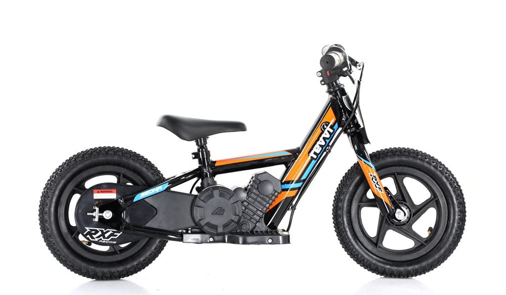 The Revvi 12" Kids Electric Balance Bike in Orange features a black frame with orange and blue accents, wide treaded wheels, and a lightweight build. It includes a padded seat, handlebars with grips, and a faux engine detail on the frame, providing an exciting riding experience without needing to twist the throttle.
