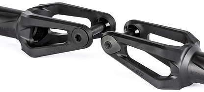 Two black Ethic DTC Merrow V3 8/12STD IHC stunt scooter forks with angular, open-frame designs are positioned facing each other. Each lightweight fork features a central bolt and has "Ethic DTC" branding on the surface.