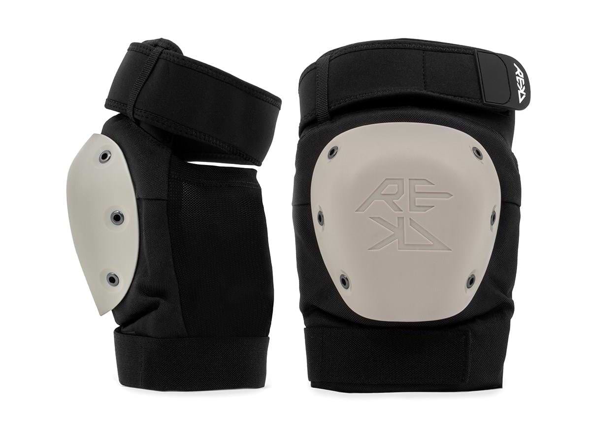 A REKD Shield Triple Skate Protection Pad Set in black and beige, featuring reinforced hard shells, adjustable straps, and "REKD" branding. Designed by REKD for reliable action sport protection during intense activities.