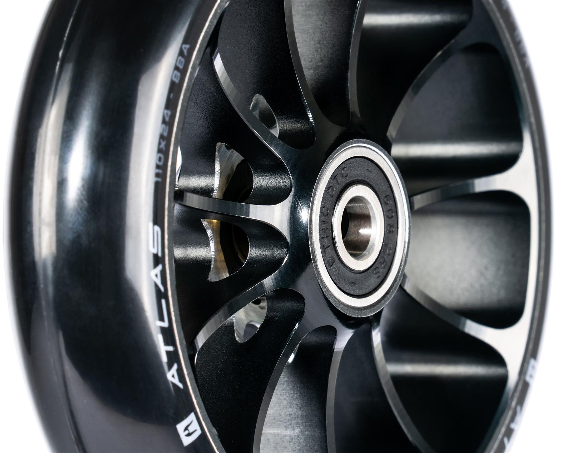 Close-up of the Ethic DTC Atlas 110mm Stunt Scooter Wheel in black, showing metal spokes, central bearing, and "ATLAS" with "110 x 24 - 88A" printed on the side for a lightweight stunt scooter design by Ethic.