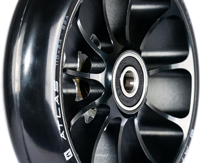 Close-up of the Ethic DTC Atlas 110mm Stunt Scooter Wheel in black, showing metal spokes, central bearing, and "ATLAS" with "110 x 24 - 88A" printed on the side for a lightweight stunt scooter design by Ethic.