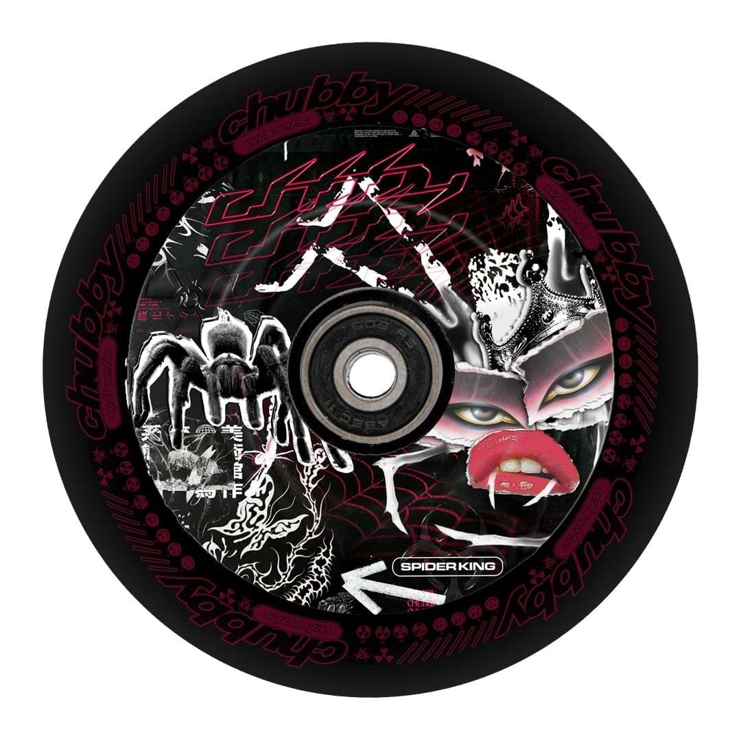 The Chubby Hollowcore 110mm Stunt Scooter Wheel - Spider King showcases a striking design featuring intricate white and red patterns on a black wheel. The artwork includes a large spider, stylized text, and a face with exaggerated lips, adorned with the phrases "Chubby Grape Juice" and "spider king." This design embodies the artistry synonymous with Chubby's craftsmanship.