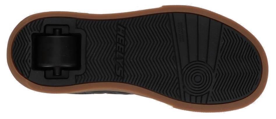 The image displays the sole of the Heelys Goleeh Boys Shoes in Black/White/Gum, featuring a brown gum outer edge, single rear wheel, and textured low-top court grip—classic elements from the Heelys brand.
