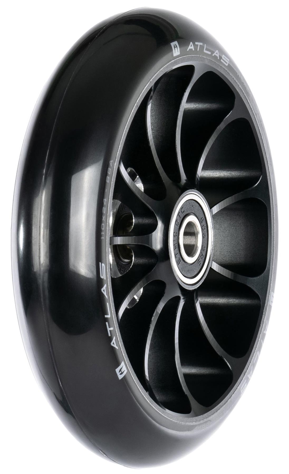 A close-up of the Ethic DTC Atlas 110mm Stunt Scooter Wheel in black shows its metal core, silver accents, exposed ball bearings, and "ATLAS" branding along the rim—highlighting this lightweight wheel from Ethic.