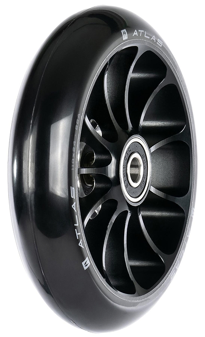 A close-up of the Ethic DTC Atlas 110mm Stunt Scooter Wheel in black shows its metal core, silver accents, exposed ball bearings, and "ATLAS" branding along the rim—highlighting this lightweight wheel from Ethic.