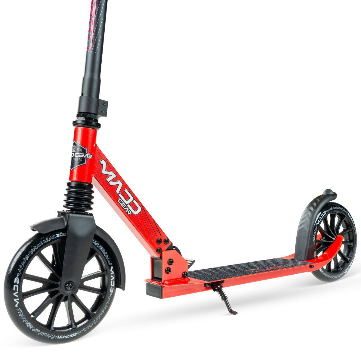 The Madd Gear Metro Cruise 250 Foldable Commuter Scooter in black/red features large black wheels, a foot stand, and "MADD GEAR" branding. Designed for adults, it is shown side-on against a white background.