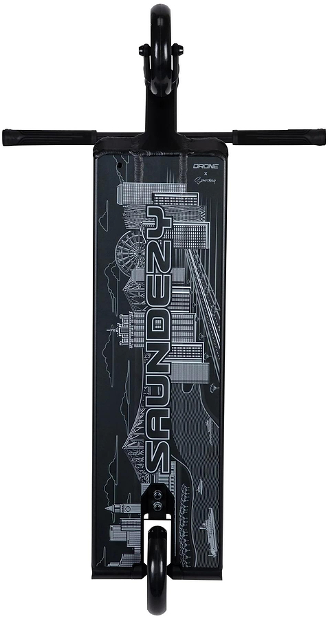 Top-down view of the Drone Nexus Kai Saunders 'Saundezy' Signature Stunt Scooter deck in black, featuring bold white "SAUNDEZY" lettering and white line art of buildings and a Ferris wheel. Brand: Drone.