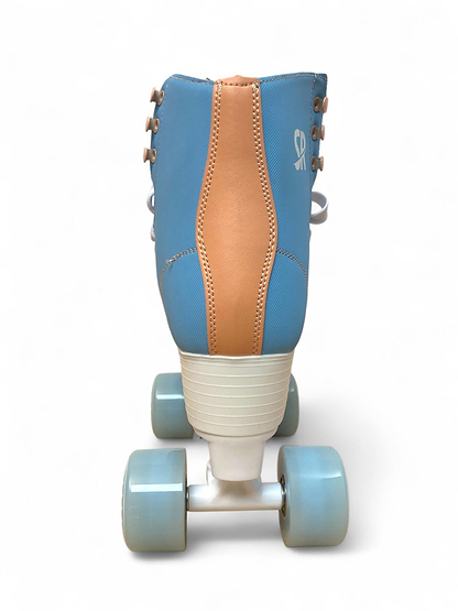 The Supreme Malibu Quad Roller Skates - Light Blue by Supreme are retro-style beginner skates with a light blue and tan design, white laces, and four light blue wheels on a white base, shown from behind against a plain white background.