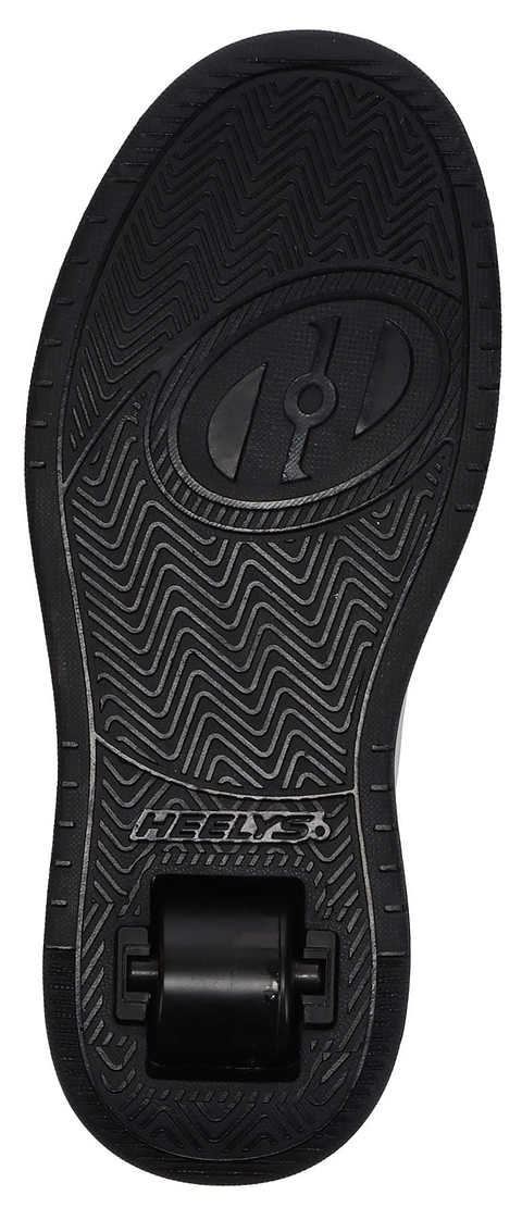 The image shows the underside of a Heelys x Hello Kitty Kama HKC Girls Shoe in light pink, black, and white, featuring a single wheel in the heel and a textured zigzag sole with "HEELYS" visible near the heel.