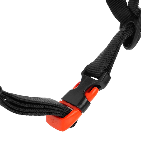 Close-up of the CORE Action Sports Skate / Scooter Helmet’s black nylon strap, featuring a black plastic buckle with a bright orange release button—designed by CORE for secure and convenient fastening, similar to those used on action sports helmets.