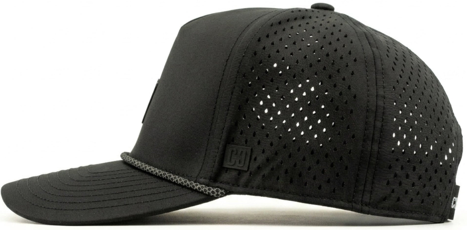 The CORE Aero Rope Cap - Black is displayed in a side view against a white background. This performance cap from CORE features a curved brim and ventilated, perforated side panels for enhanced breathability. Subtle CORE logo detailing complements its modern design.