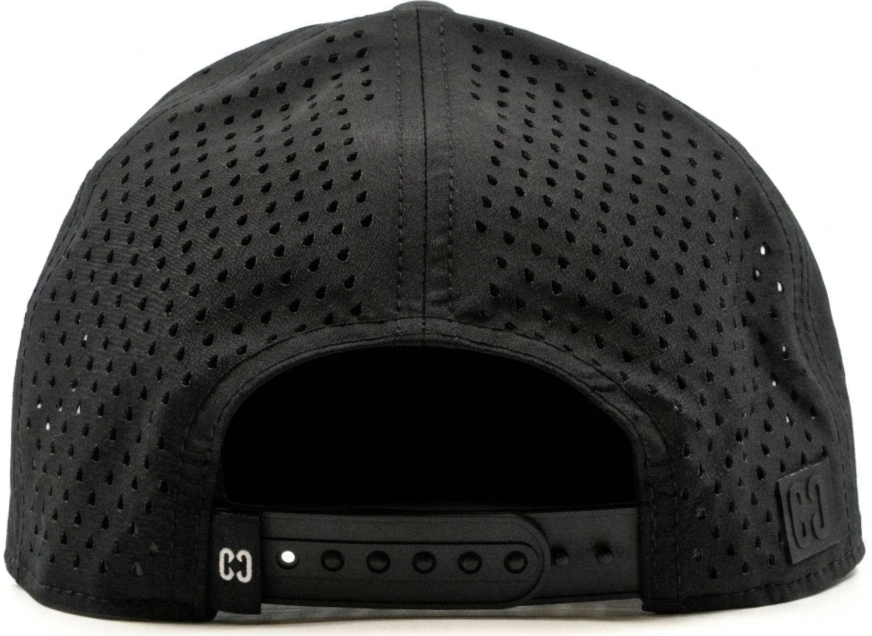The CORE Aero Rope Cap - Black is shown from the back, highlighting its black perforated snapback design with an adjustable strap featuring holes and a small CORE logo tag on the left side.