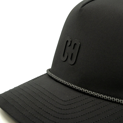 A close-up view of the CORE Aero Rope Cap - Black, featuring a raised “C8” logo and a decorative gray braided rope above the brim.
