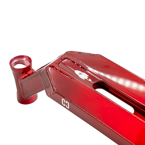 Close-up of the CORE Apollo Red Stunt Scooter Deck – 5" shows a shiny red metal frame, visible weld seams, cylindrical head tube, and white “C3” logo. Its angular shapes and top tube cutout highlight this durable stunt scooter deck from CORE.