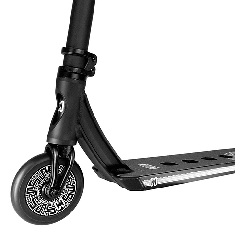 Close-up of the front section of a CORE CL1 Complete Stunt Scooter by CORE, showcasing its single wheel adorned with a decorative white pattern. The scooter features a robust black frame and a deck with circular cutouts and the logo positioned near the front. The handlebars and rear wheel remain out of view.