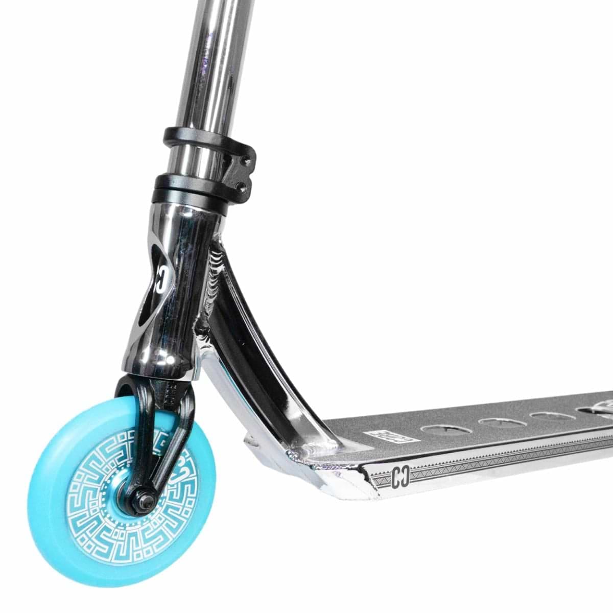 Close-up of the front section of a chrome and teal stunt scooter, showcasing a metallic finish with a patterned design on its CORE CL1 blue wheels, enhanced by premium aftermarket components.