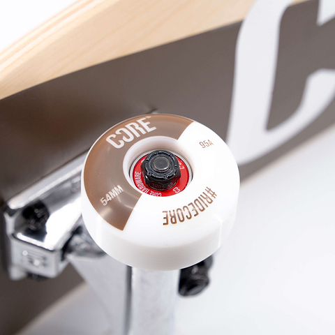Close-up of a CORE C2 Raw Split Complete Skateboard wheel with white and brown detailing, mounted on a silver truck.