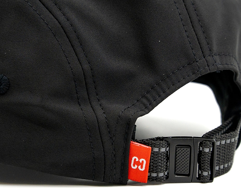 Close-up of the back of the CORE Performance Cap - Black / Reflective, featuring a black adjustable strap and a small red tag labeled “C3” near the opening, crafted from breathable fabric by CORE for all-day comfort.