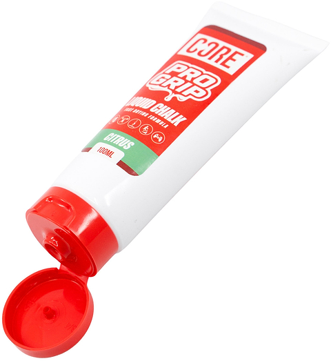 A white tube labeled “CORE PRO Grip 100ml Liquid Chalk - Citrus” by CORE, featuring a red cap and lying on its side with the cap open. The label highlights its citrus scent and vegan formula. This liquid chalk is crafted to provide a secure hold, helping you maintain optimal grip during even your most intense workouts.