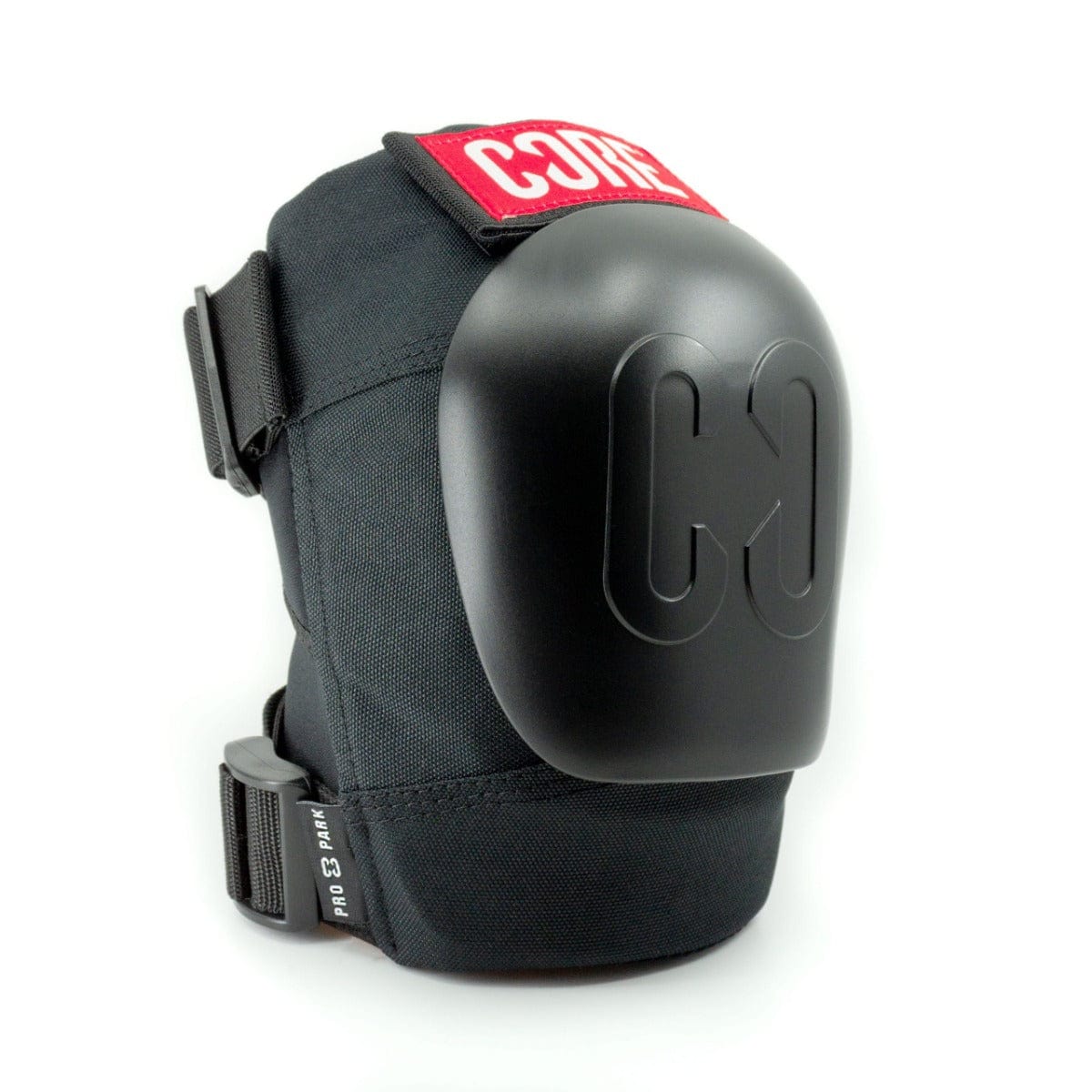 A black pair of CORE Pro Park Knee Skate Protection Pads featuring a hard shell cover and adjustable straps, ideal for skatepark riders. The product prominently displays the "CORE" brand name in striking red and white on the upper part, alongside a distinctive "C3" logo on the shell, offering dynamic size system customization for an optimal fit.
