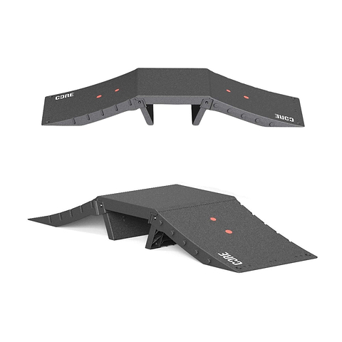 Two views of the CORE Mini Funbox Ramp Set - 2 Kickers & Flat Deck by CORE are shown: the black ramp set with "CORE" and two red dots, featuring a raised center and sloped sides. One image is top-down, the other from a lower angle.