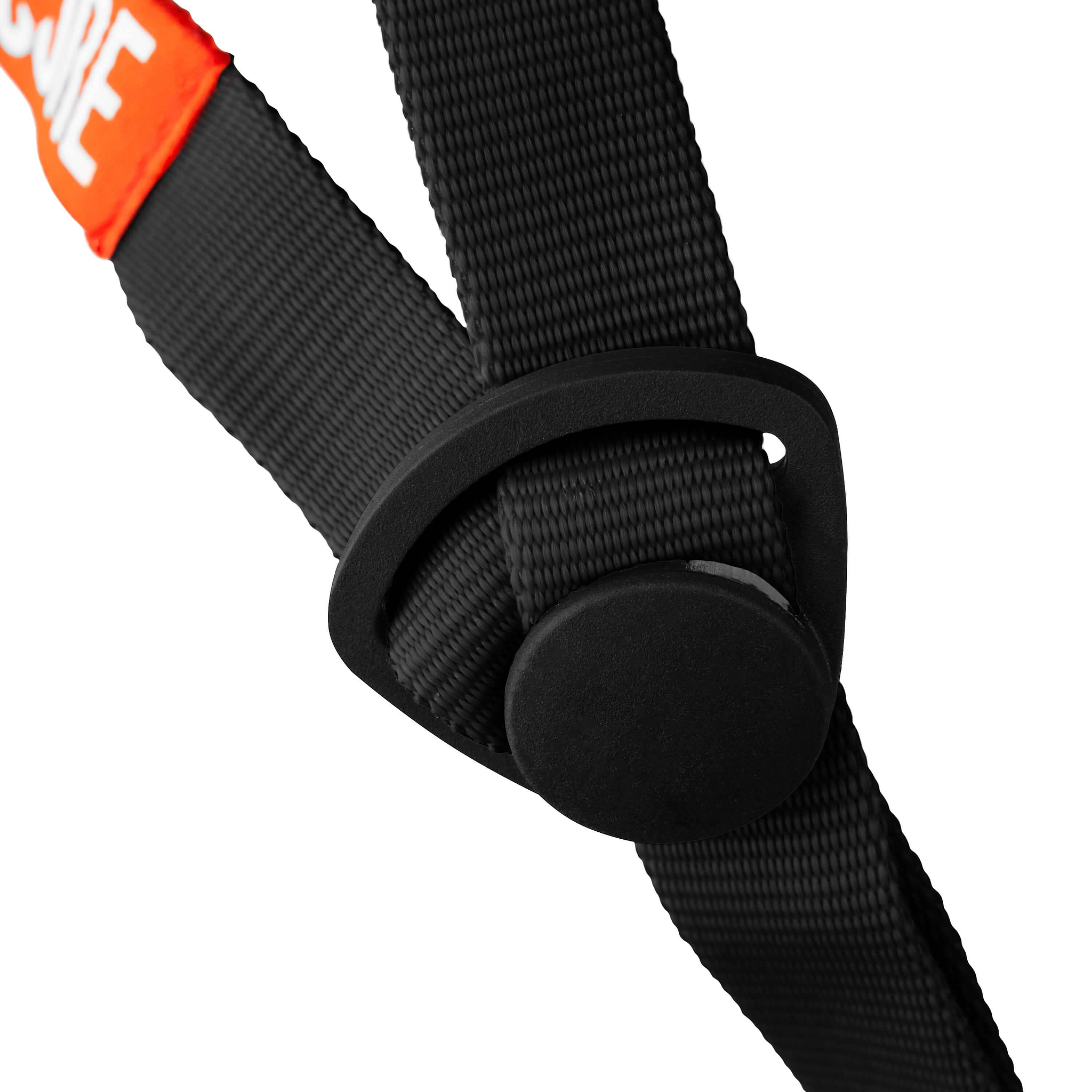 Close-up of a black nylon strap with a plastic adjustment buckle, part of an orange label visible at the top left corner—designed to provide the best fit for the CORE Street Skate / Scooter Helmet - Grey by CORE or your favorite skate helmet.