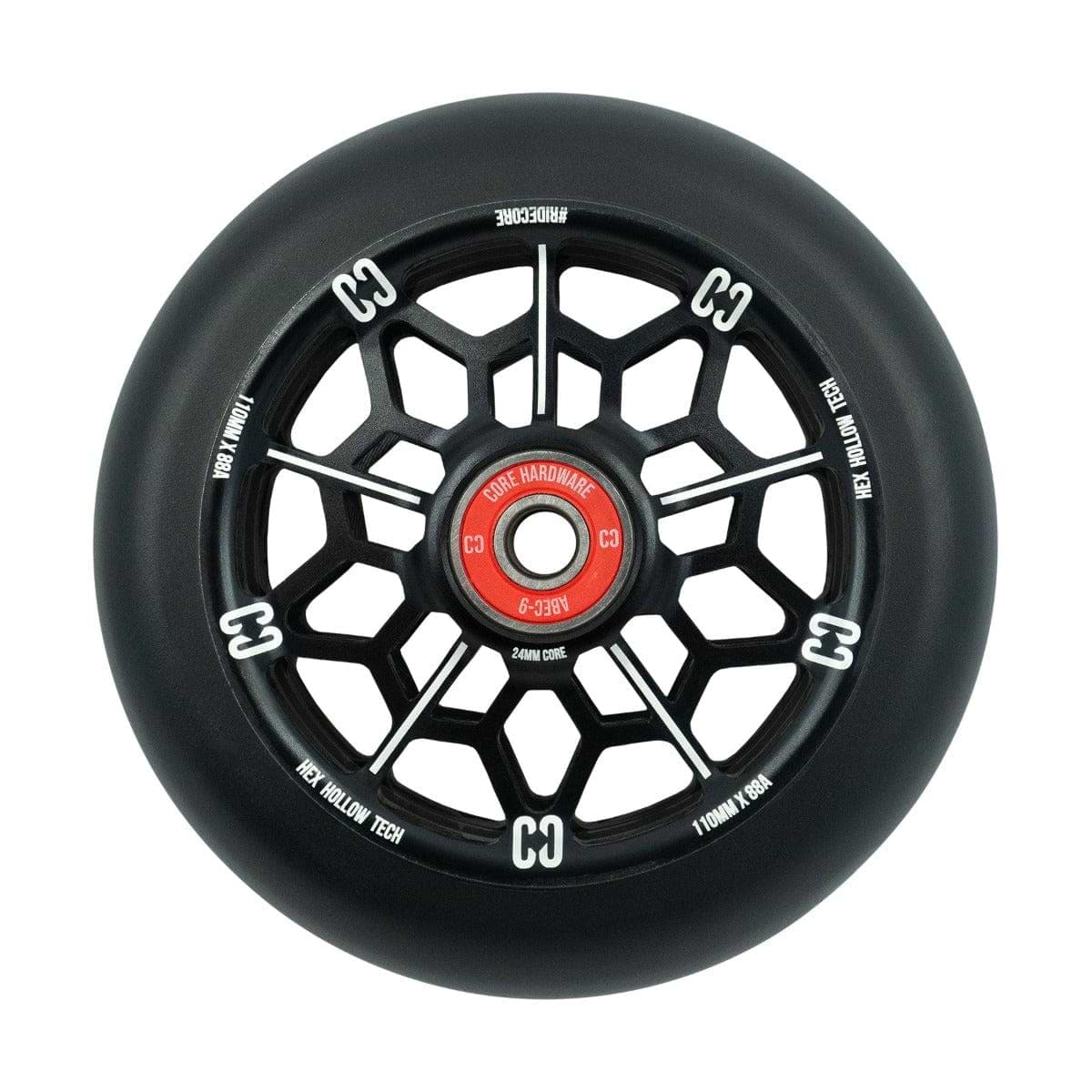 A detailed view of the CORE Hex Hollow Core 110mm Stunt Scooter Wheel in black and red, featuring a unique geometric spoke design. The wheel is marked with "CC" and "High Hollow Tech" on the outer rim and includes ABEC 9 Bearings. The red central hub proudly displays "Core Hardware.