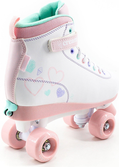 The CREAM Scoop Hearts Adjustable Quad Roller Skates in White/Pink feature a white body adorned with light blue, green, and purple heart and diamond doodles on the sides. These pastel-colored quad skates have pink wheels, pink laces, and a teal inner lining—making them the perfect choice for beginners who want both comfort and standout style.