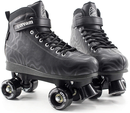 A pair of CREAM Scoop Wave Adjustable Quad Roller Skates in black, crafted from vegan leather and featuring laces, ankle straps, and four wheels each. These adjustable quad skates showcase subtle wavy patterns along with “CREAM” branding on the strap and wheels.