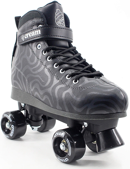 The CREAM Scoop Wave Adjustable Quad Roller Skates in Black, crafted from vegan leather, feature striking wavy silver patterns, black laces, and a Velcro strap branded with "CREAM." Designed with a high-top silhouette for style and support, these skates come equipped with black wheels and a matching toe stop. Perfect for beginner skaters, they offer both comfort and standout style.