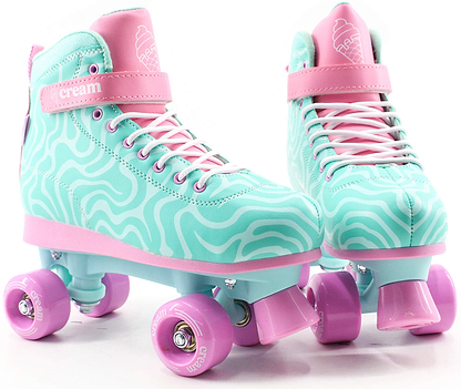Step into style and comfort with the CREAM Scoop Wave Adjustable Quad Roller Skates in teal and pink. These beginner-friendly skates feature wavy patterns, pink wheels, pink laces, and an ankle strap branded with “CREAM.” An ice cream cone design decorates the tongue, while their vegan leather construction ensures they’re both stylish and comfortable for new skaters.