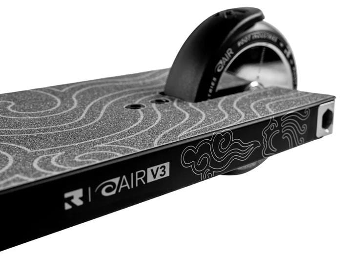 Close-up of the Root Industries AIR RS V3 Complete Stunt Scooter - Black, showing its deck with a textured grip, cloud patterns, and "AIR V3" label near the rear wheel.
