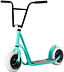 The Rocker Rolla Big Wheel Complete Scooter - Teal by Rocker showcases a stylish teal and black design with striking large white wheels and a wooden foot deck. Its robust black handlebars with end grips make it an ideal choice for those who value the nimbleness of stunt scooters.