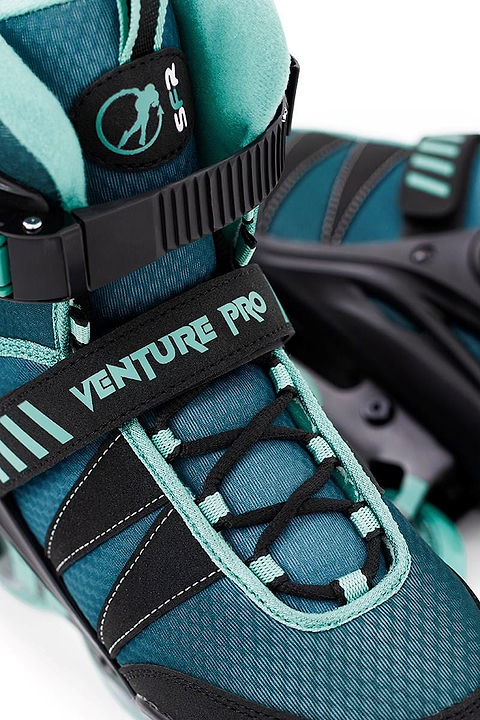 A close-up of the SFR Venture Pro Inline Skates - Teal reveals its teal and black design with "VENTURE PRO" on the strap. It features ABEC-7 bearings, a striped pattern, smooth laces, comfortable padded lining, and durable urethane wheels.