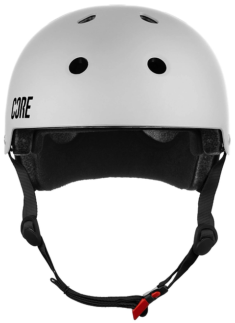 The CORE Street Skate / Scooter Helmet - White by CORE is shown from the front, featuring ventilation holes, black interior padding, an adjustable black strap with a red buckle—ideal for safe and stylish street skating.