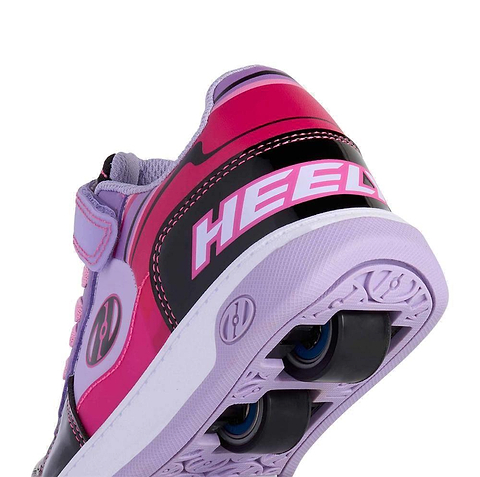 A close-up of the heel of Heelys Rezerve Low X2 Girls Shoes in Black, Purple, and Pink shows "HEEL" on the back and two black wheels in the sole, highlighting their sporty two-wheel design by Heelys.