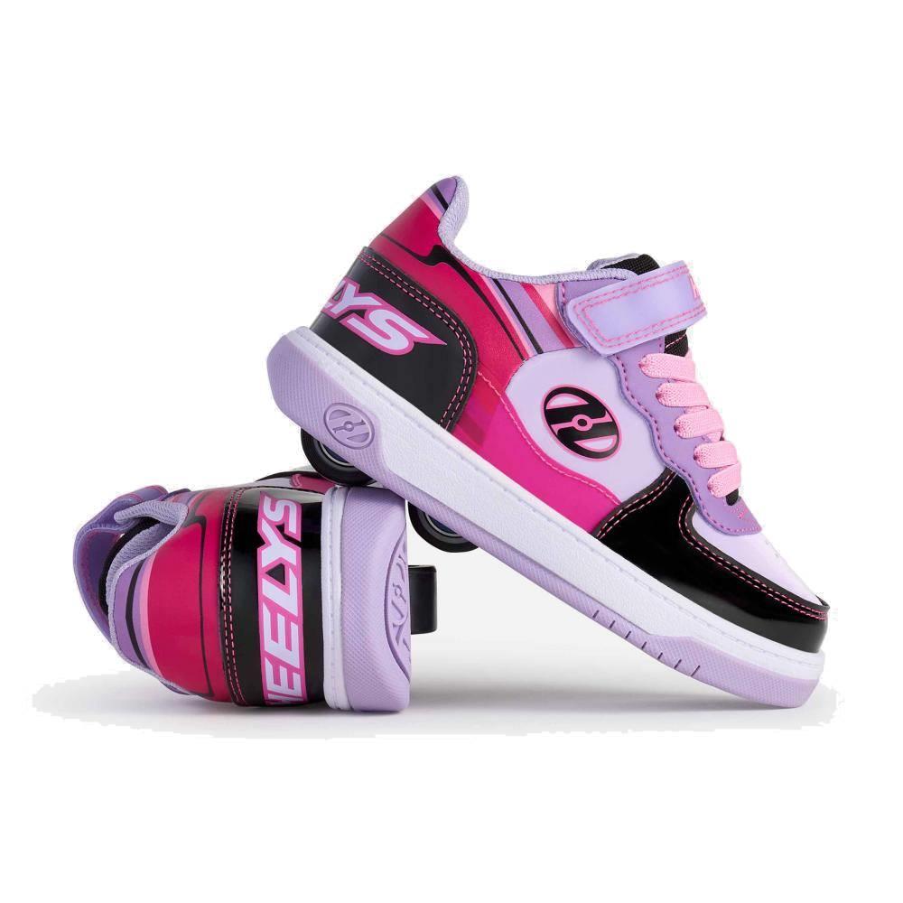 A pair of Heelys Rezerve Low X2 Girls Shoes in black, purple, and pink with a two-wheel design, featuring the Heelys logo and laces—one shoe stands upright, the other lies on its side.