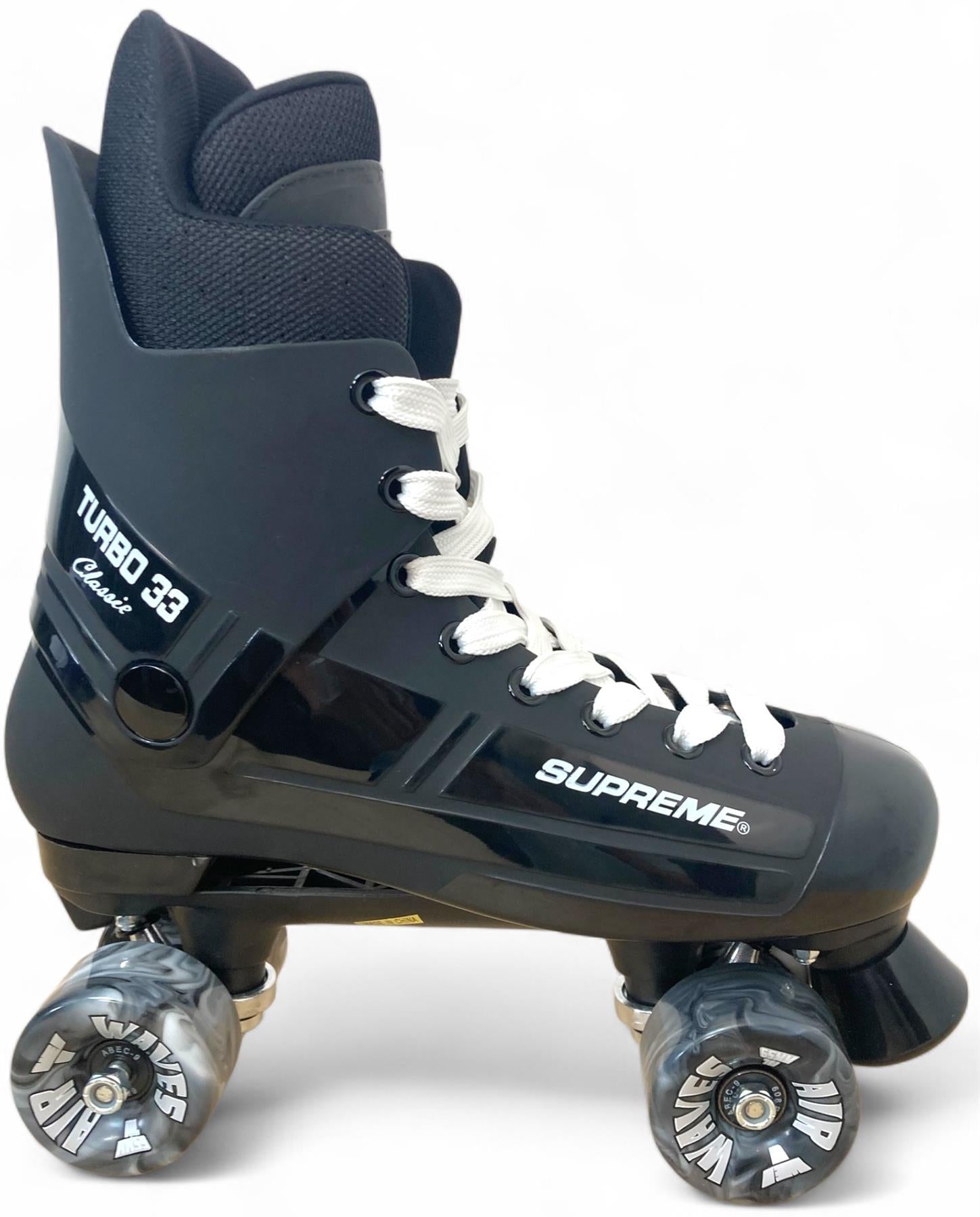 The Supreme Turbo 33 Nylon Quad Roller Skates in black, with bold “Supreme Turbo 33” branding and black swirl wheels, are set against a clean white background.