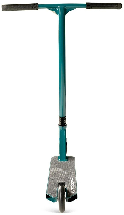 A denim Madd Gear Viral KAOS Complete Stunt Scooter by MGP is shown from the front, highlighting its handlebars, single front wheel, and textured deck with the brand name displayed.